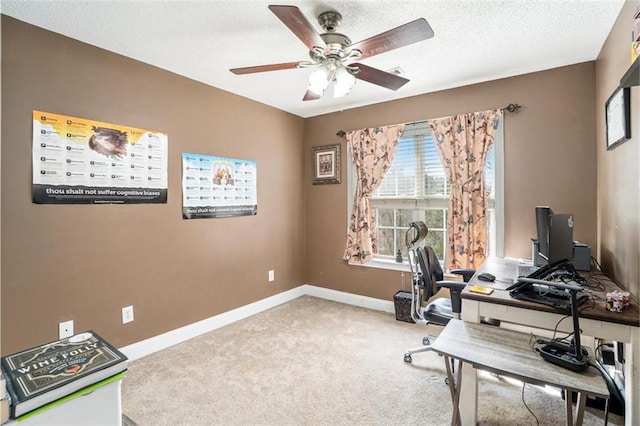 office space featuring light carpet, ceiling fan, and a textured ceiling