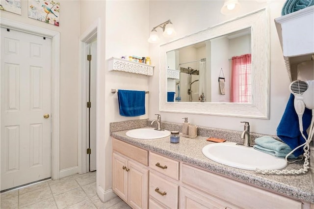 bathroom featuring tile patterned floors, vanity, and a shower
