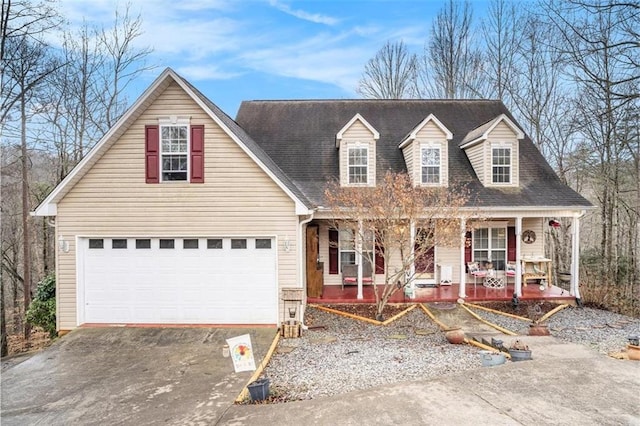 cape cod-style house with a garage and covered porch