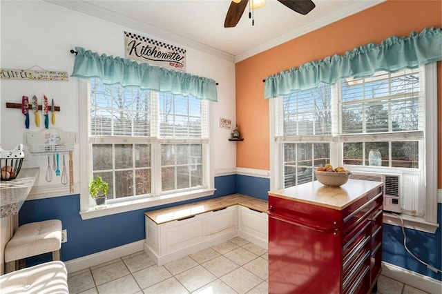 interior space featuring ceiling fan, a healthy amount of sunlight, ornamental molding, and light tile patterned floors