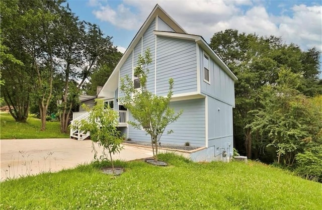 view of side of home with a yard