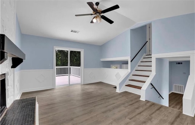 unfurnished living room featuring hardwood / wood-style flooring, vaulted ceiling, and ceiling fan