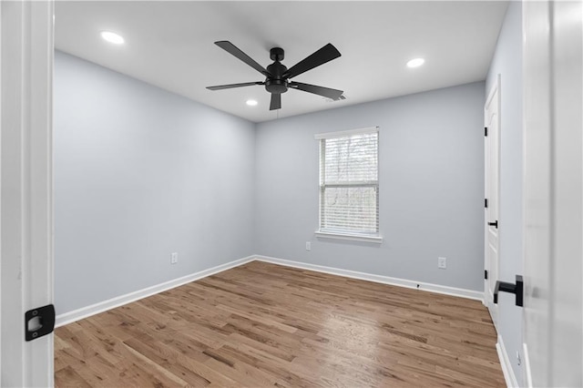 empty room with a ceiling fan, recessed lighting, wood finished floors, and baseboards