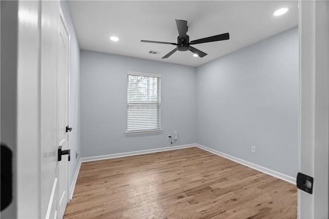 unfurnished room featuring visible vents, baseboards, light wood-style floors, and ceiling fan