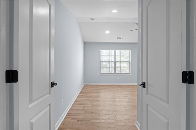 corridor with visible vents, recessed lighting, baseboards, and light wood-style floors