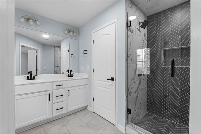 bathroom with a sink, a marble finish shower, and double vanity