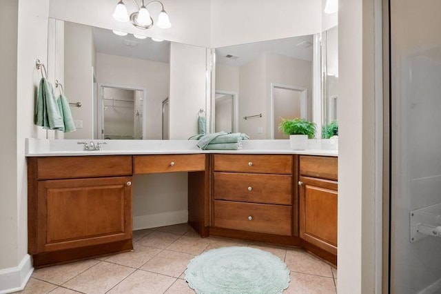 bathroom featuring tile patterned flooring, vanity, and a shower with shower door