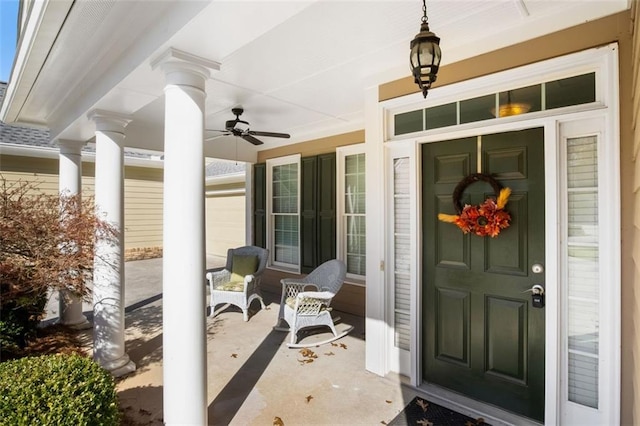 view of exterior entry featuring a porch and ceiling fan