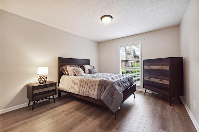 6851 Roswell Rd Unit E1, Atlanta, GA 30328 - bedroom featuring a textured ceiling, baseboards, and hardwood / wood-style floors
