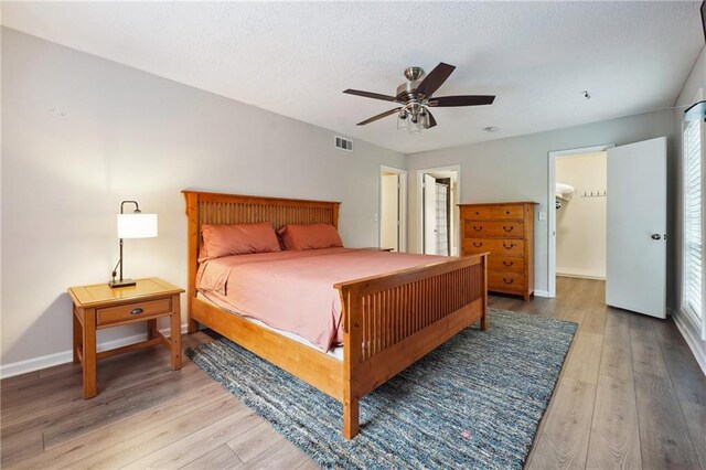 6851 Roswell Rd Unit E1, Atlanta, GA 30328 - bedroom featuring visible vents, a ceiling fan, light wood-style flooring, and baseboards