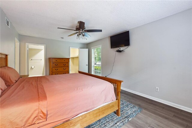 6851 Roswell Rd Unit E1, Atlanta, GA 30328 - bedroom featuring a textured ceiling, visible vents, wood finished floors, baseboards, and connected bathroom