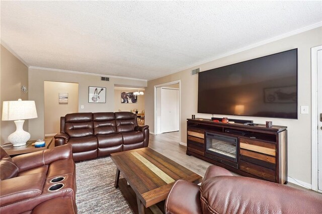 6851 Roswell Rd Unit E1, Atlanta, GA 30328 - living area featuring ornamental molding, a textured ceiling, and wood finished floors