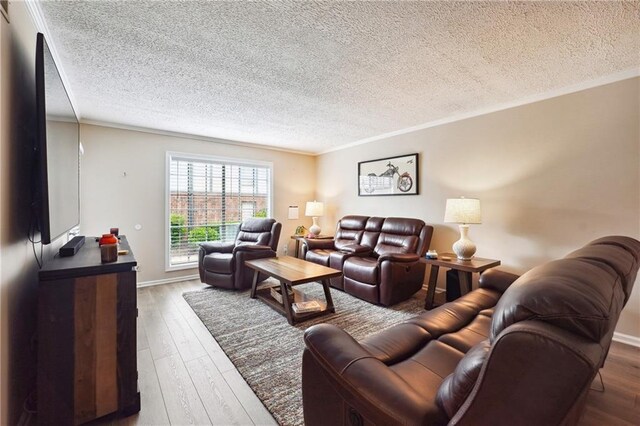 6851 Roswell Rd Unit E1, Atlanta, GA 30328 - living room with wood-type flooring, a textured ceiling, and crown molding