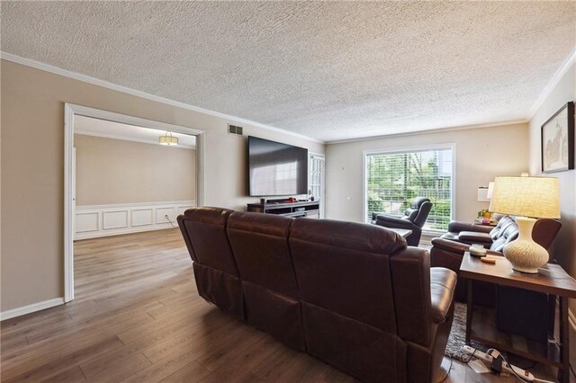 6851 Roswell Rd Unit E1, Atlanta, GA 30328 - living room with visible vents, a textured ceiling, crown molding, and wood finished floors