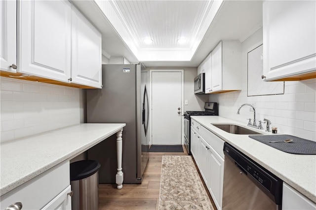 6851 Roswell Rd Unit E1, Atlanta, GA 30328 - kitchen featuring a sink, appliances with stainless steel finishes, white cabinets, and light wood-style floors