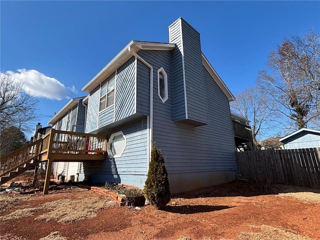 view of side of property featuring a wooden deck