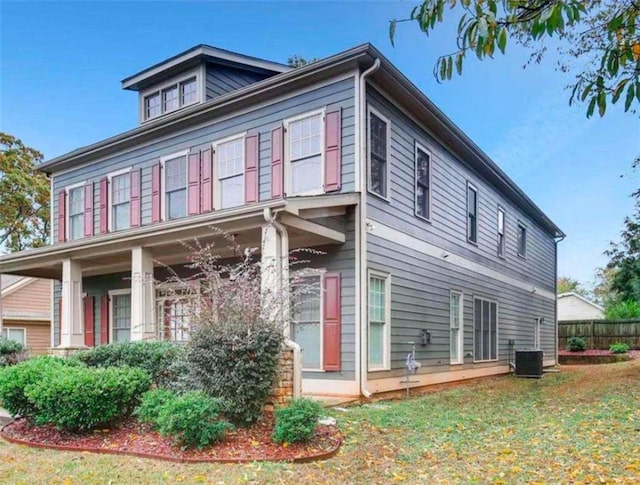 view of side of home featuring a lawn and central air condition unit