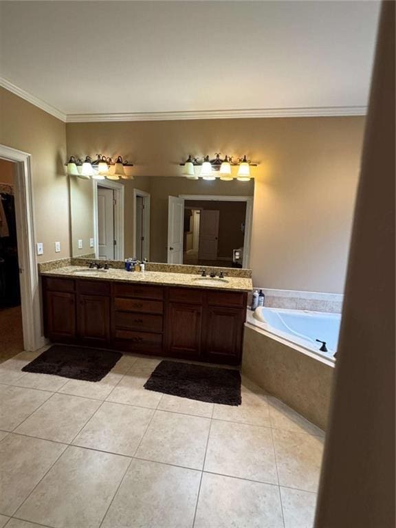 bathroom featuring tile patterned floors, vanity, tiled tub, and ornamental molding