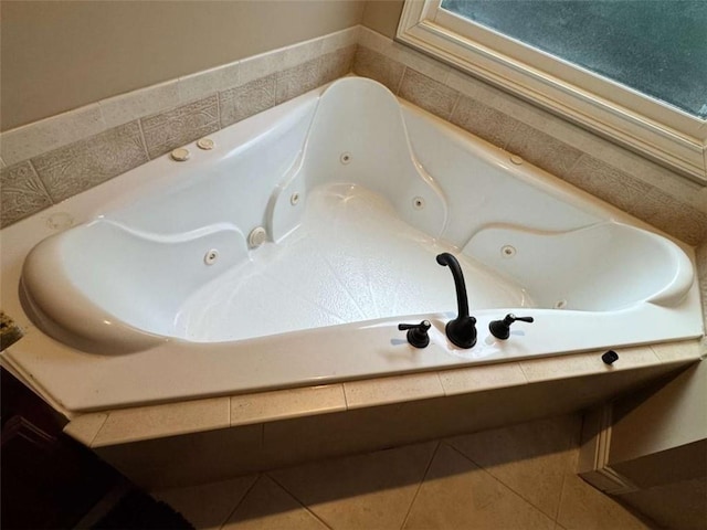 bathroom featuring a relaxing tiled tub and tile patterned floors