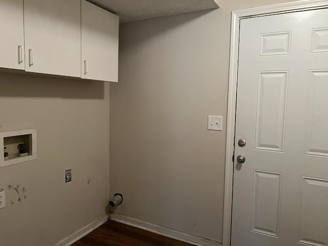 clothes washing area featuring cabinets, electric dryer hookup, dark hardwood / wood-style floors, and washer hookup