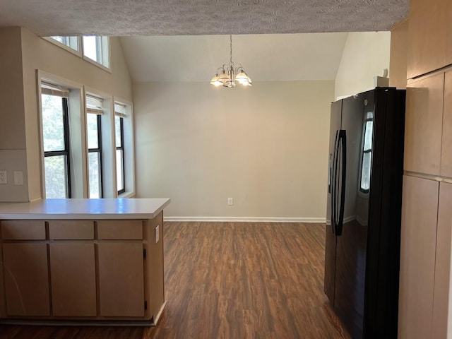 kitchen featuring dark wood-type flooring, vaulted ceiling, black refrigerator with ice dispenser, kitchen peninsula, and a notable chandelier