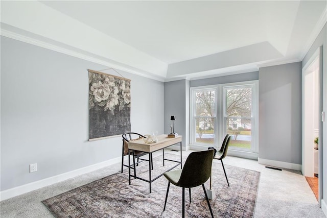 office space with light carpet, visible vents, a tray ceiling, and baseboards