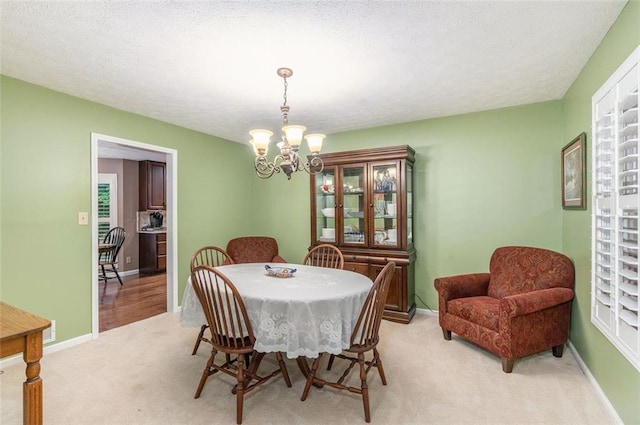 324 Kibbee Rd, Mcdonough, GA 30252 - dining space featuring a chandelier, light colored carpet, and baseboards