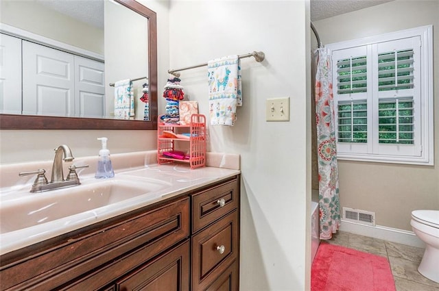 324 Kibbee Rd, Mcdonough, GA 30252 - bathroom with vanity, toilet, a textured ceiling, shower / tub combo, and baseboards