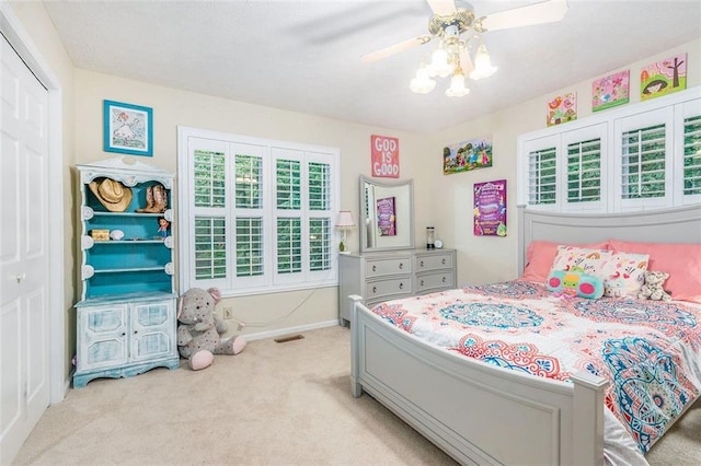 324 Kibbee Rd, Mcdonough, GA 30252 - bedroom featuring light carpet, a closet, baseboards, and a ceiling fan