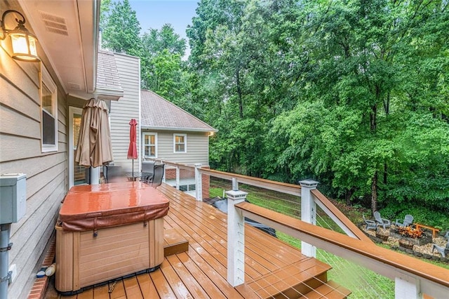 324 Kibbee Rd, Mcdonough, GA 30252 - wooden terrace with a fire pit, a hot tub, and view of wooded area