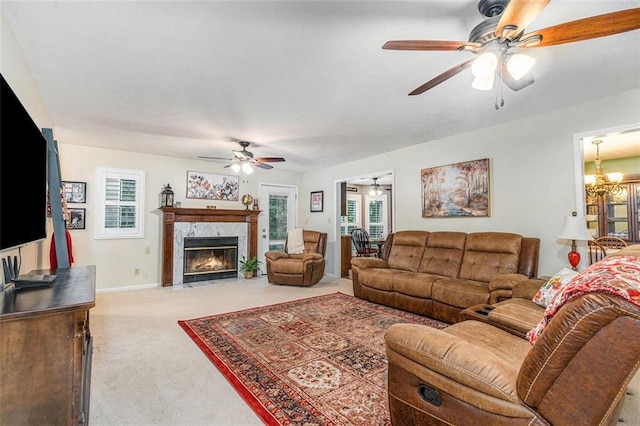 324 Kibbee Rd, Mcdonough, GA 30252 - living area featuring ceiling fan, carpet, a high end fireplace, a chandelier, and baseboards