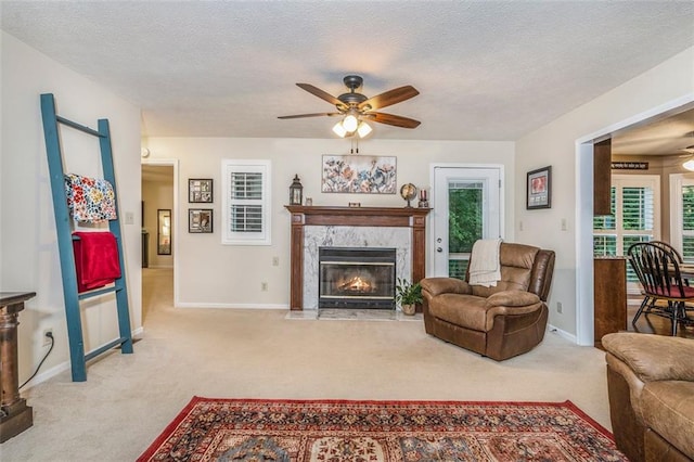324 Kibbee Rd, Mcdonough, GA 30252 - carpeted living room with a ceiling fan, a fireplace, baseboards, and a textured ceiling