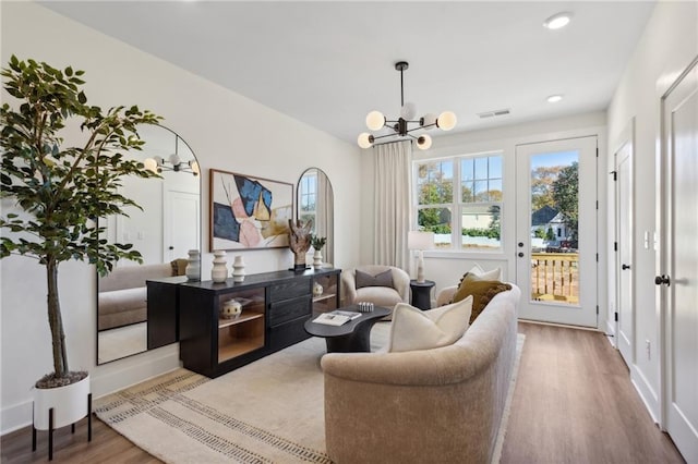 sitting room with a chandelier and hardwood / wood-style flooring