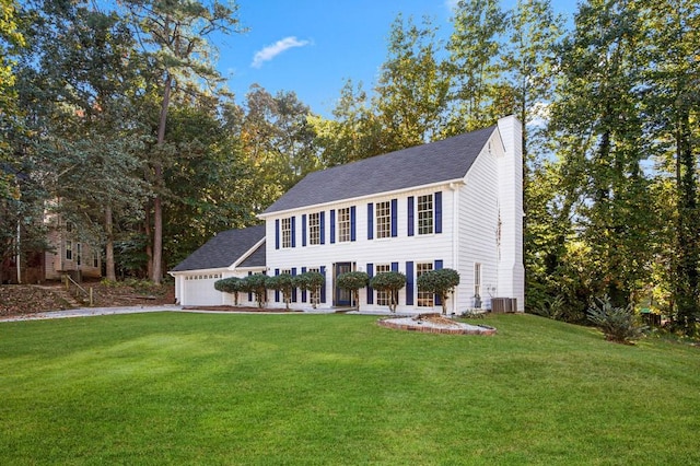 colonial house featuring central AC, a front lawn, a chimney, and an attached garage