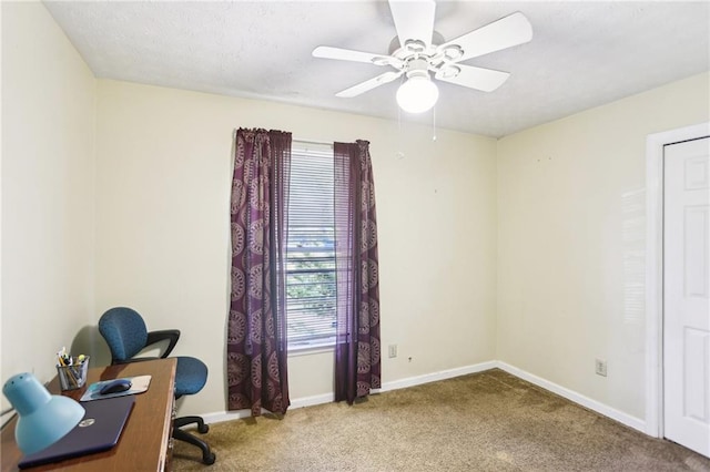 office area with carpet flooring, ceiling fan, and baseboards