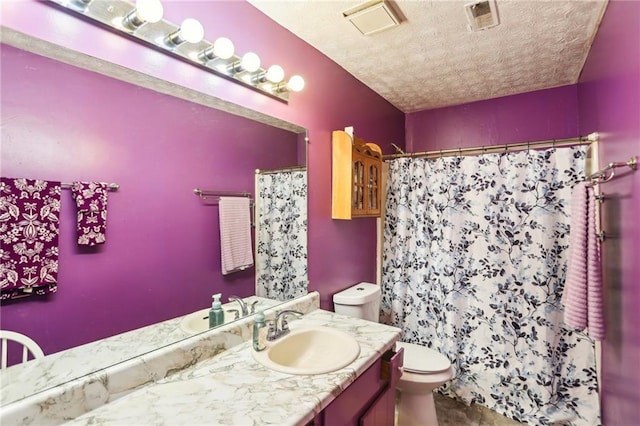 full bathroom featuring visible vents, toilet, curtained shower, a textured ceiling, and vanity