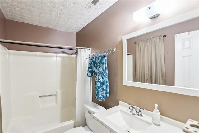 full bath with shower / bath combo, vanity, toilet, and a textured ceiling