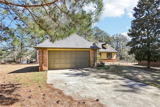 view of front of home featuring a garage, driveway, and brick siding