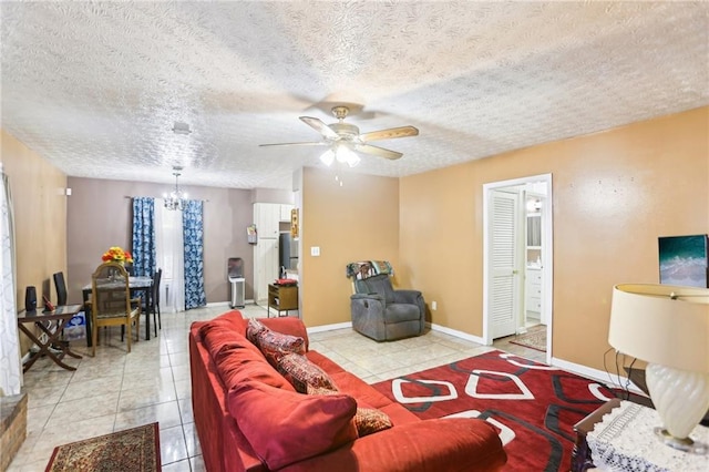 living area featuring light tile patterned floors, baseboards, and a textured ceiling