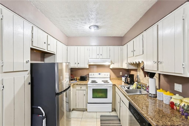 kitchen with light tile patterned floors, stainless steel appliances, a sink, a textured ceiling, and under cabinet range hood