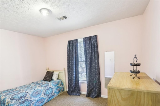 bedroom featuring baseboards, visible vents, a textured ceiling, and carpet flooring