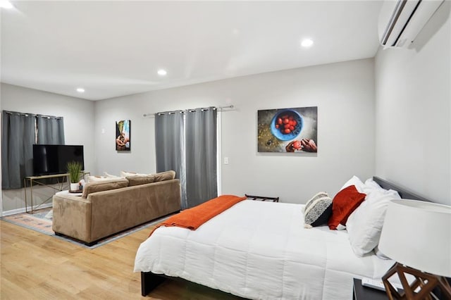 97 Griffin St NW, Atlanta, GA 30314 - bedroom featuring a wall mounted air conditioner, light wood-type flooring, and recessed lighting