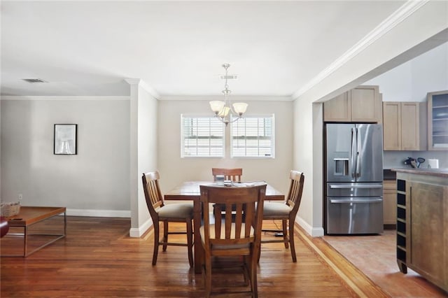 97 Griffin St NW, Atlanta, GA 30314 - dining area featuring light wood-style floors, a chandelier, and ornamental molding
