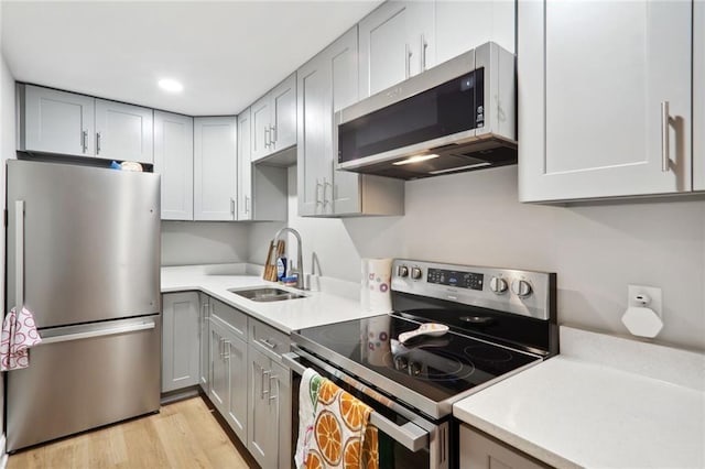 97 Griffin St NW, Atlanta, GA 30314 - kitchen with appliances with stainless steel finishes, gray cabinets, light countertops, light wood-type flooring, and recessed lighting