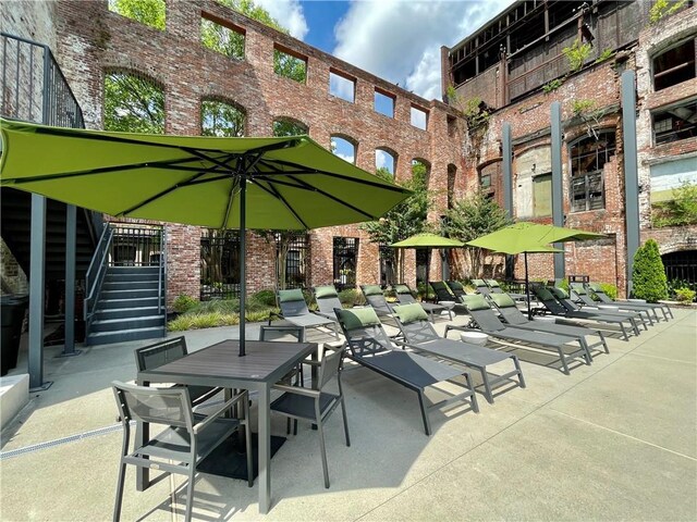 exterior space featuring stairs and outdoor dining space
