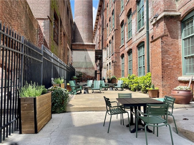 view of patio with outdoor dining area and fence