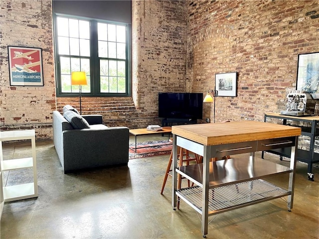 interior space featuring brick wall and finished concrete floors
