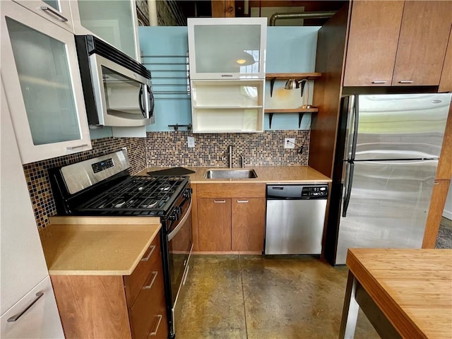 kitchen with a sink, light countertops, backsplash, and stainless steel appliances