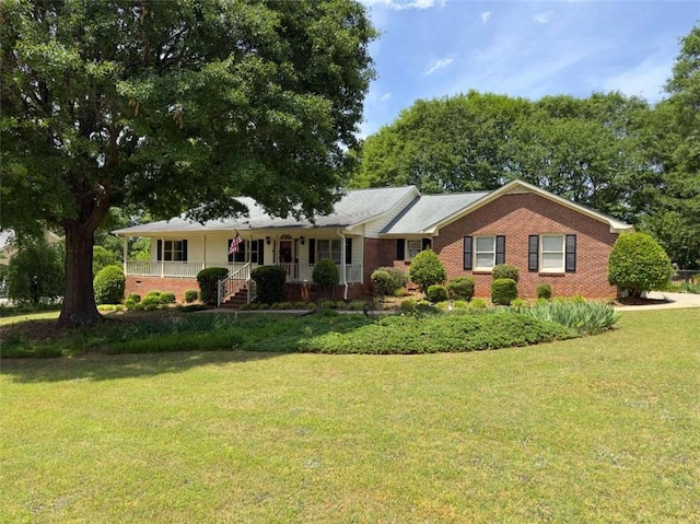 ranch-style house featuring a front lawn, covered porch, and brick siding