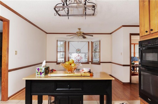 interior space with ceiling fan, a textured ceiling, light hardwood / wood-style flooring, and crown molding